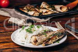 Baked hake carcasses with rice