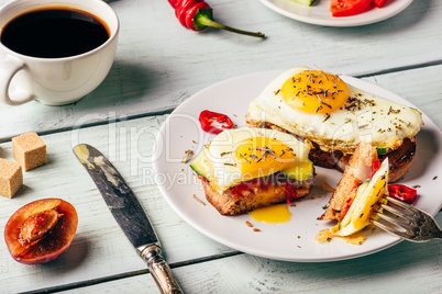 Toasts with vegetables and fried egg and cup of coffee