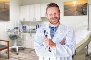 Caucasian Male Doctor Standing In Medical Office