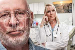 Empathetic Doctor Standing Behind Troubled Senior Adult Man In Medical O