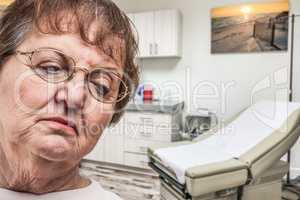 Worried Senior Adult Woman Waiting in Doctor Medical Office