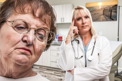 Empathetic Doctor Standing Behind Troubled Senior Adult Woman