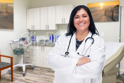 Hispanic Female Doctor Standing In Medical Office