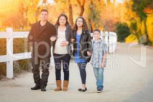 Hispanic Pregnant Family Walking On Path