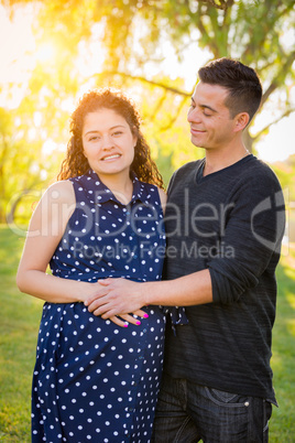 Hispanic Pregnant Young Couple Portrait Outdoors