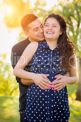 Hispanic Pregnant Young Couple Portrait Outdoors