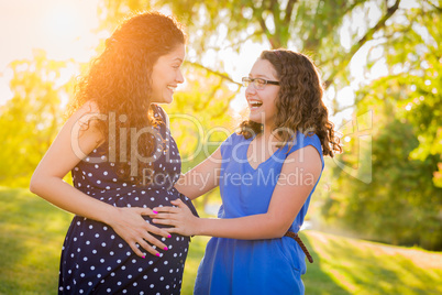 Hispanic Pregnant Mother With Young Daughter Outdoors