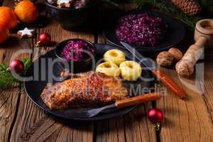 Roast goose with baked apples, red cabbage and dumplings