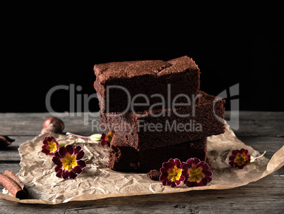 stack of baked square pieces of chocolate brownie cake