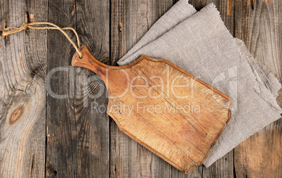 empty old brown wooden cutting board with handle