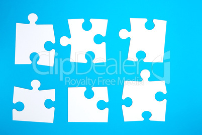 empty white big puzzles on a blue background