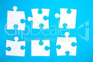 empty white big puzzles on a blue background