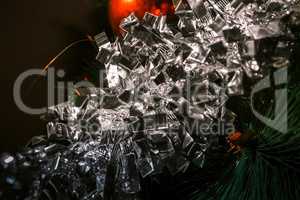 Dark background with tinsel and ball