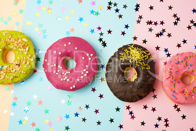 round donuts with various fillings and sprinkles on an abstract