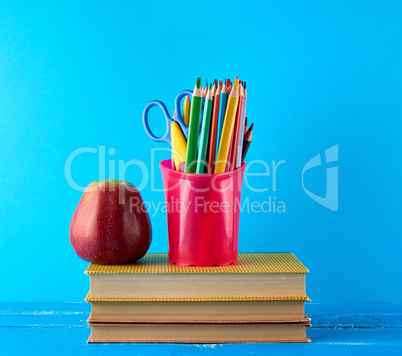 red apple and stack of books