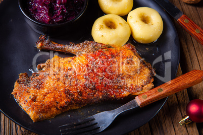 Roast goose with baked apples, red cabbage and dumplings