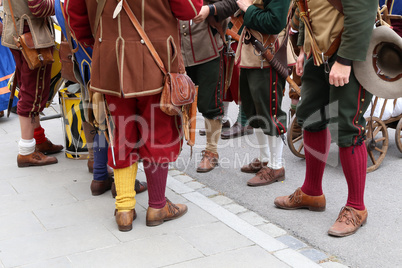 Reconstructors in musketeers clothes on a city holiday