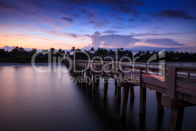 Sunrise over Naples Pier where people fish at dawn in Naples,