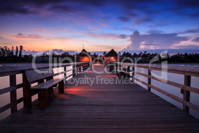 Sunrise over Naples Pier where people fish at dawn in Naples,