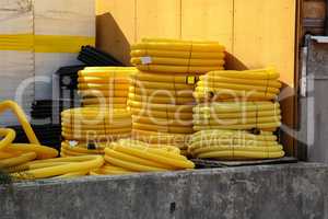 Plastic pipes lie on the construction site