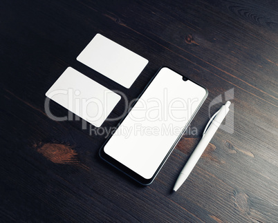Smartphone, business cards, pen