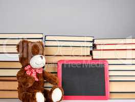 brown teddy bear and empty black board in red frame