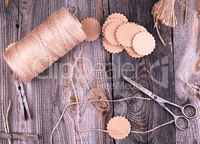 coil of brown rope, paper tags and old scissors