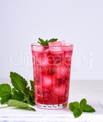 summer refreshing drink with berries of cranberries and pieces o