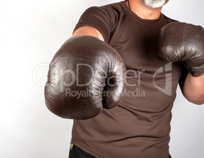 young man stands in a boxing rack