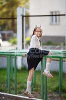 Girl climbs on horizontal bar