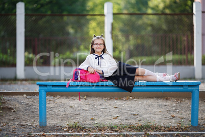 Schoolgirl resting on a bench