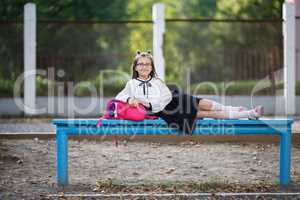 Schoolgirl resting on a bench