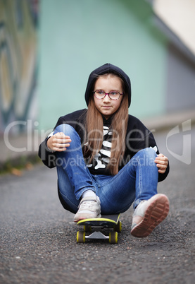 Girl sitting on skateboard
