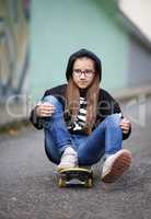 Girl sitting on skateboard