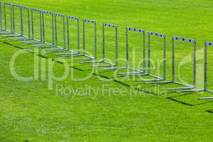 many hurdles on green grass