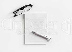 Copybook, glasses, pen