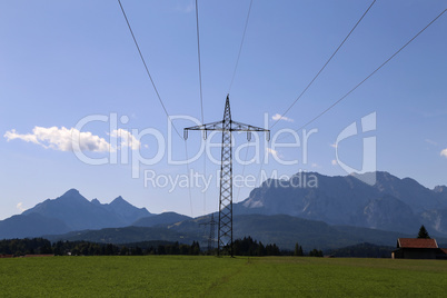 Steel electricity pylon on bright blue sky