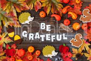 Colorful Autumn Decoration, Text Be Grateful, Wooden Background