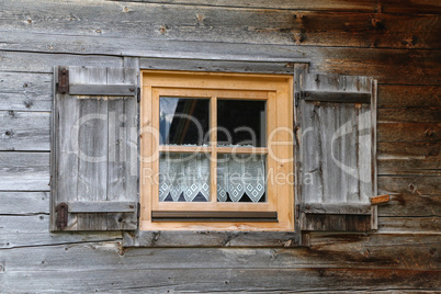 Windows with shutters in a wooden house