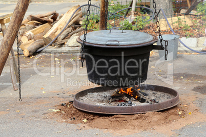 Food is cooked in a cauldron on a fire