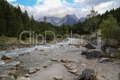 Mountain landscape with a small river in the Alps