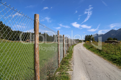 Metal mesh fence along the field road