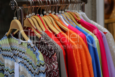 Clothes hanging on a counter in a store