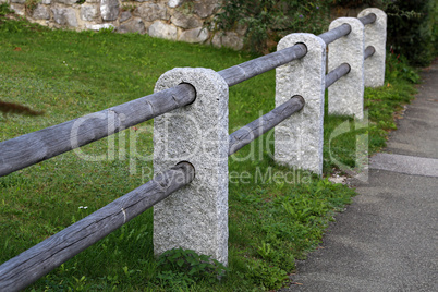 Fence of stone columns and wooden bars