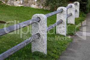 Fence of stone columns and wooden bars