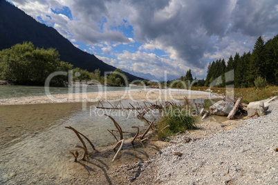 Mountain landscape with a small river in the Alps