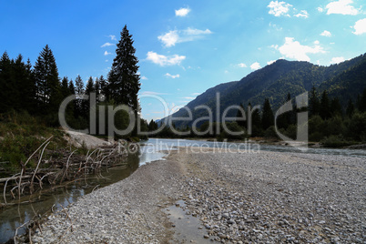 Mountain landscape with a small river in the Alps