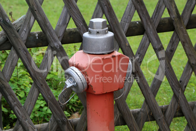 Typical red hydrant stands on the street