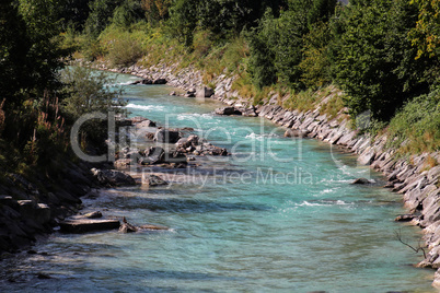 Mountain landscape with a small river in the Alps