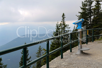 Observation deck with tourist binoculars in the mountain